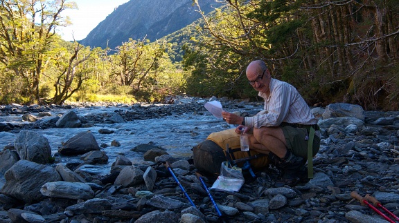 Studying maps by the river