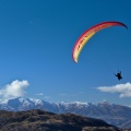 Tandem paraglider in the sky above Queenstown Hill