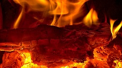 Log aglow in a roaring fireplace