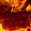 Log aglow in a roaring fireplace