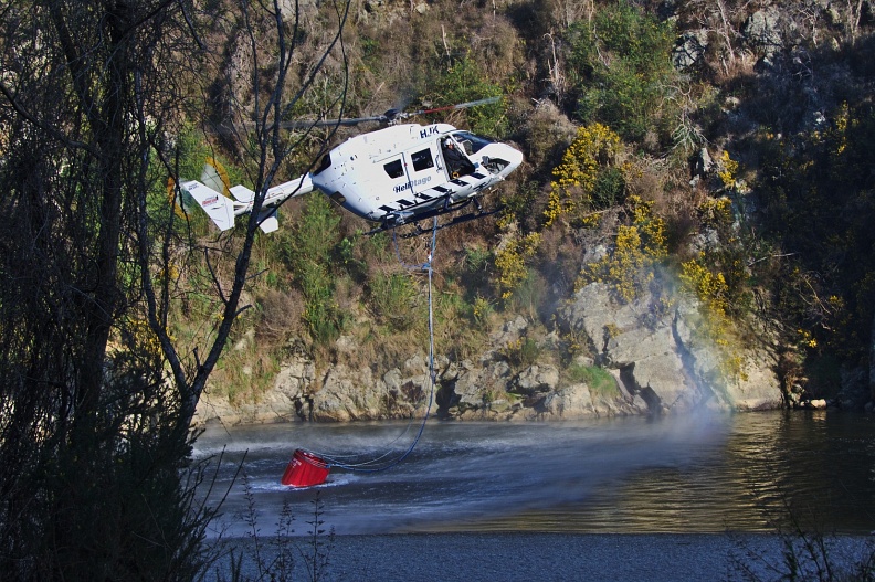 Helicopter refilling monsoon bucket from Taieri River