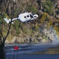 Helicopter refilling monsoon bucket from Taieri River