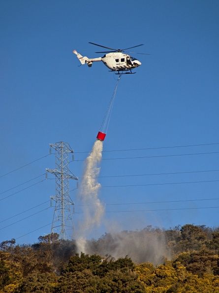 Helicopter putting up fire near power lines