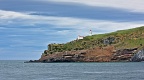 Taiaroa Head with lighthouse on calm overcast day