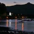 Historic lighthouse and yacht club at night