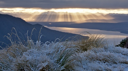 Warm sun rays and cold snow above Lake Te Anau