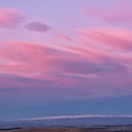 Pink morning clouds over distant mountain range
