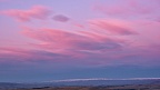 Pink morning clouds over distant mountain range