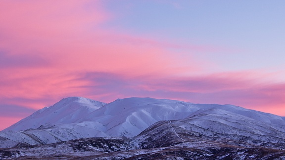 Snowy Saint Bathans Range and morning pink clouds