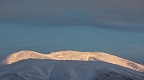 Ribbon of sunlight on snowy mountains