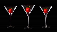 Three Martini cocktail glasses with red strawberries