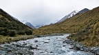 Cameron River and mountains in the head of the valley in clouds