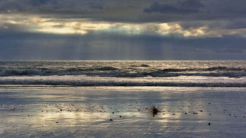 Sunbeams and reflections on the beach