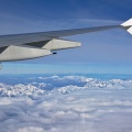 Airplane wing and Southern Alps through a window