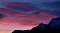 Dramatic red clouds and snowy peaks
