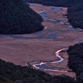 Meanders at Routeburn Flats with red sky reflecting in the water