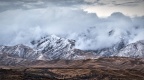 Snowy mountains in rolling clouds