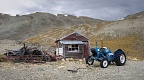 Old tractor, hut, and pile of stuff