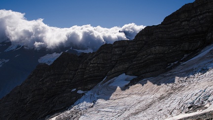 Layered rock, snow, and clouds
