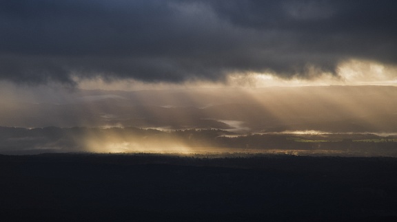 Morning crepuscular rays under layer of clouds